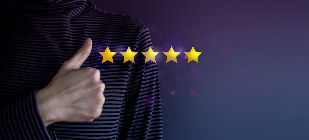 Person giving a thumbs up and five star review for AC repair.
