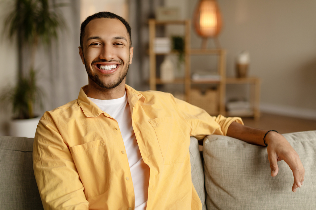 Happy man smiling into camera thanks to heating and AC repair. 