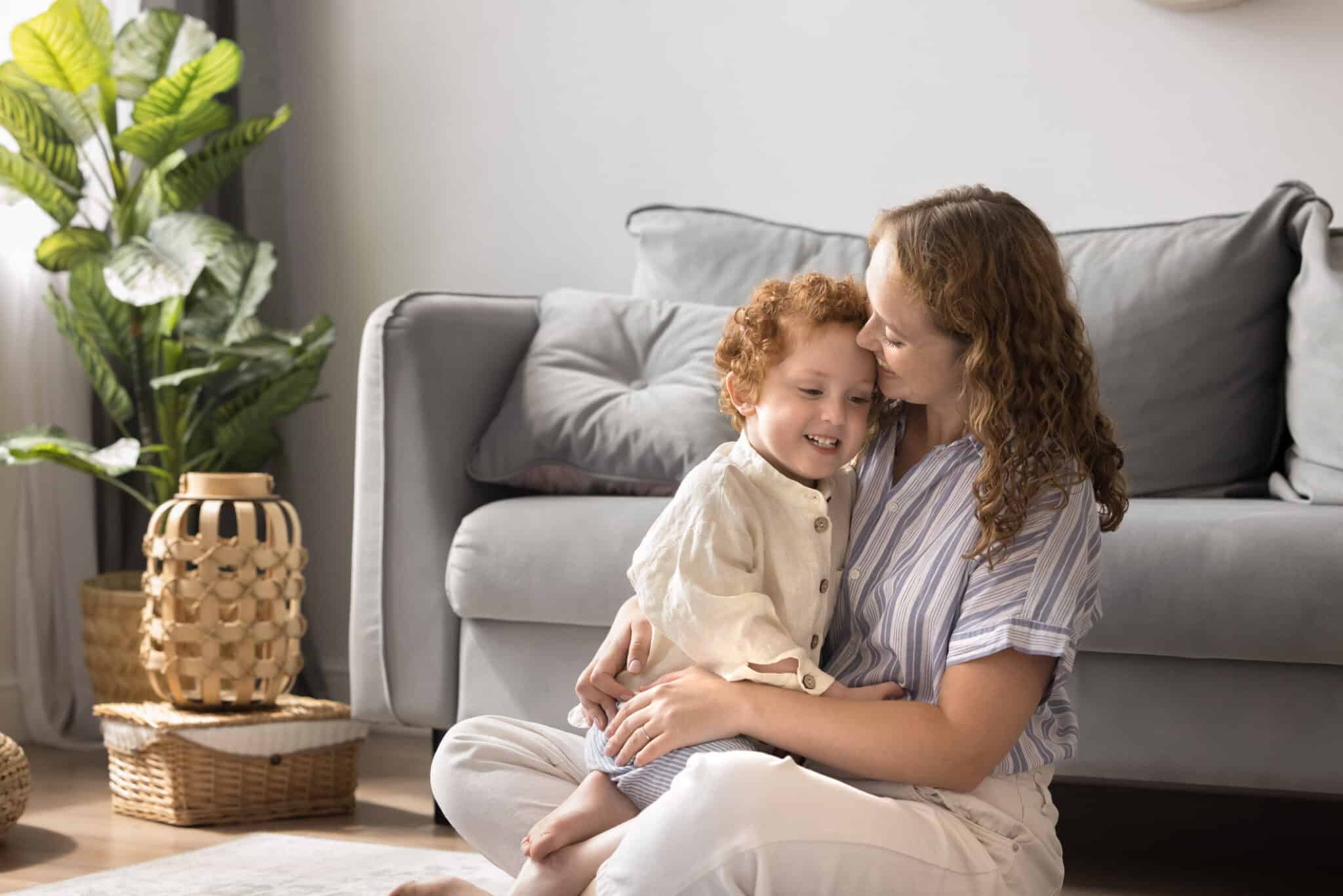 A loving young mother spends time with her little son in the fresh air at home, HVAC services.
